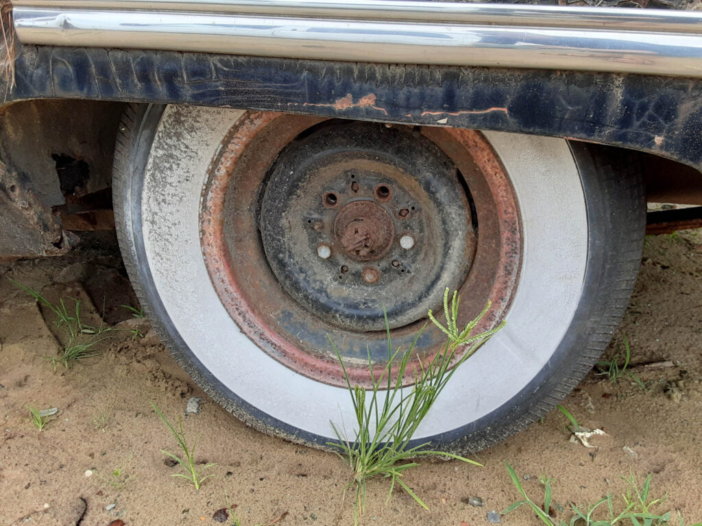 1953 Packard Cavalier wheel (hubcap inside vehicle).